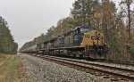 CSX 117 and 5465 wait for green with a line of covered hoppers